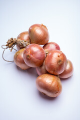 Bunch of french AOP pink onions from Roscoff village in Brittany, France