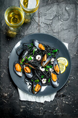 Mediterranean food. Spaghetti with cuttlefish ink, clams and white wine.