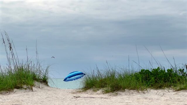 Footpath of tropical sandy island beach and beach umbrella