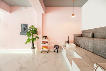 Room of a beauty salon with a sofa on a double height platform for pedicures