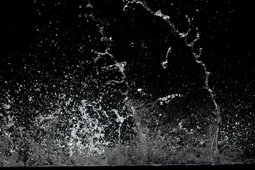 Blur Defocus Image of Water hit wall ground, explode into drop droplet. Amount Water attack impact...