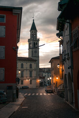Narrow street with a church and the sunset as background