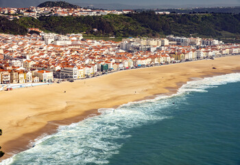 Fototapeta na wymiar high point view of Nazare. Sand beach, sea, village Nazare, Portugal.
