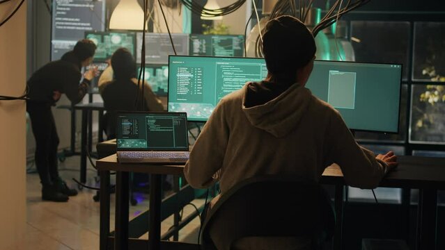 Diverse team of thieves committing cyber attack with computer malware, using trojan virus to break security server. Young hackers practicing espionage and identity theft, network encryption.