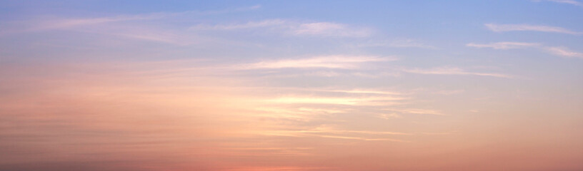 Fototapeta premium Beautiful sky painted by the sun leaving bright golden shades.Dense clouds in twilight sky in winter evening.Image of cloud sky on evening time.Evening sky scene with golden light from the setting sun