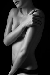 closeup of topless sexy beautiful young woman on dark background