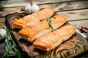 Grilled salmon fillet with garlic and rosemary.