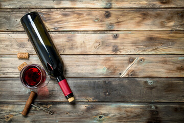 Obraz na płótnie Canvas Red wine in a wine glass with a corkscrew.