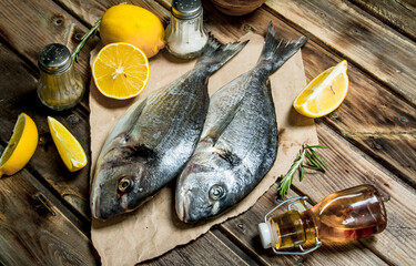 Raw sea fish dorado with lemon, herbs and aromatic spices.