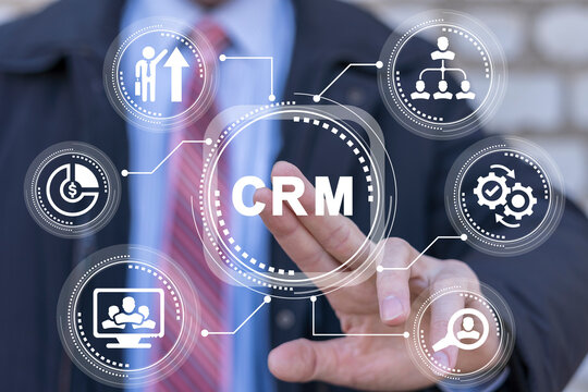 Businessman using virtual touchscreen presses abbreviation: CRM. Concept of CRM Customer Relationship Management. Marketing strategies and technologies for manage and development client interactions. - Powered by Adobe