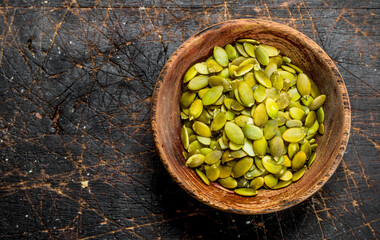 Pumpkin seeds in bowl .