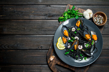 Mediterranean food. Spaghetti with cuttlefish black ink and clams.