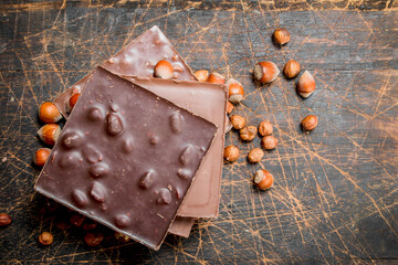 Hazelnut chocolate on wooden background.