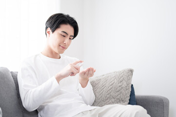 Image of young Asian male grooming with easy-to-use lotion