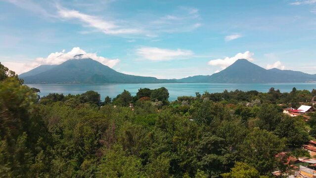 Aerial Fly Away from Lake and Volcanoes - Summer - Lake Atitlan, Panajachel, Guatemala