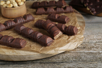 Tasty chocolate bars on wooden table, closeup