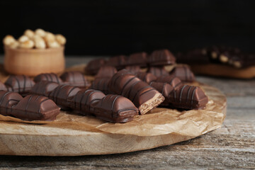 Tasty chocolate bars on wooden table, closeup