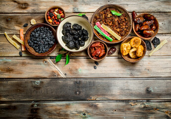 Assortment of different dried fruits in bowls.