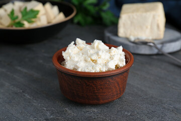 Delicious tofu cream cheese in bowl on black table, closeup