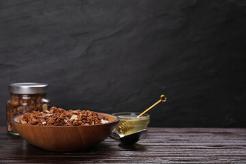 Fototapeta premium Tasty granola on wooden table. Space for text