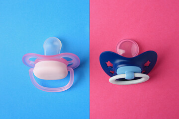Baby pacifiers on color background, flat lay