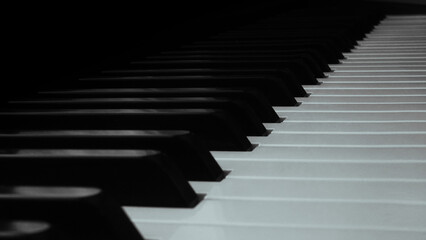 High-resolution, professional-grade photo of a piano keyboard with well-lit, glossy black and white keys. Perfect for illustrating music, performance, and creativity. 