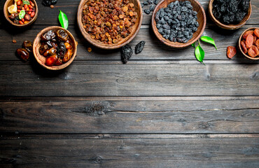 Assortment of different kinds of dried fruits in bowls.