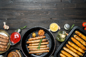 Assortment of different fried sausages with sauces.