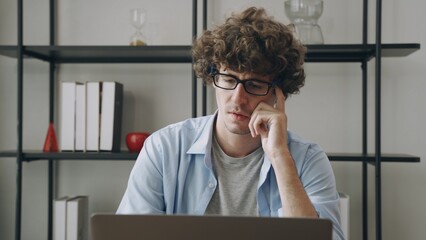 Fototapeta premium Young happy Asian businessman or freelance working and use a computer laptop and thinking idea for her business
