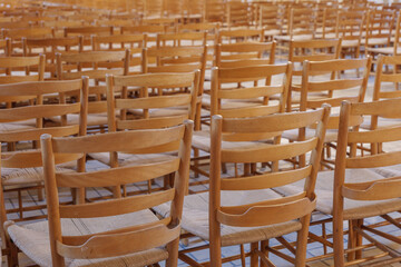 Fototapeta na wymiar Selective focus view at row of chairs without people for worshipper at nave of Protestant Church. 