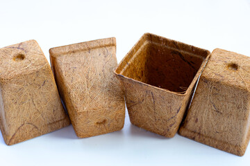 Coco coir pots on white background.