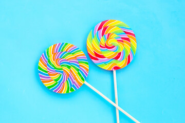 Rainbow lollipop on blue background.