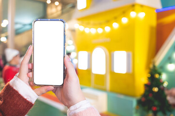 Close up women using a smartphone with an empty white screen at  night festival event.