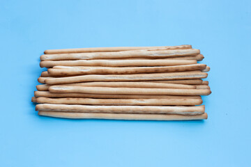 Bread sticks on blue background