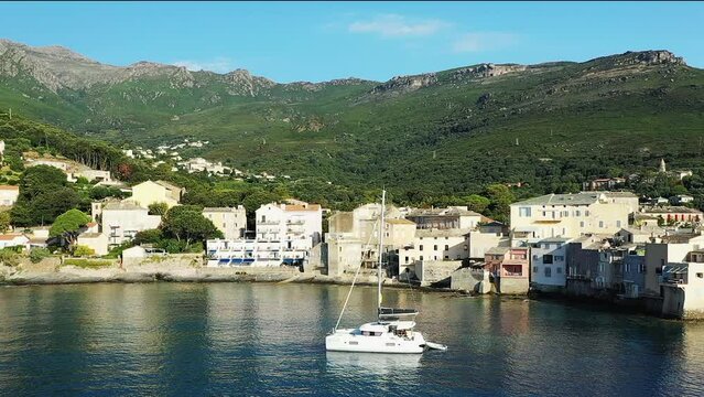 The city of Erbalunga in the middle of the arid and green mountains, in Europe, in France, in Corsica, towards Bastia, by the Mediterranean Sea, in summer, on a sunny day.