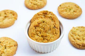 Pistachio and almond cookies on white background.