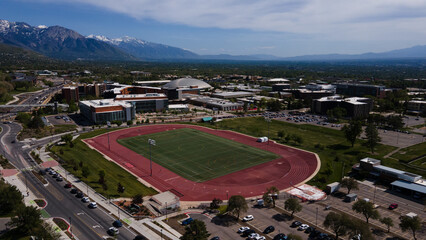 aerial shot of salt lake valley and mountains with field and university of utah in the foreground © Ethan