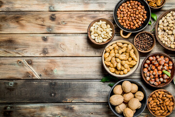 Obraz na płótnie Canvas Assortment of different nuts in bowls.