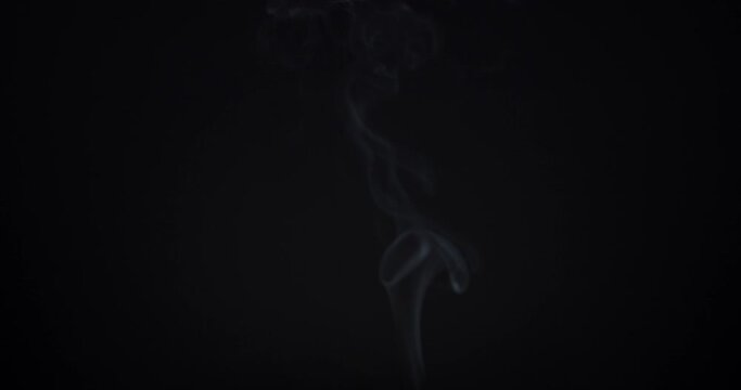 smoke rising on black background