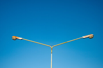 street lamp against blue sky