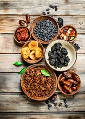 Assortment of different dried fruits in bowls.