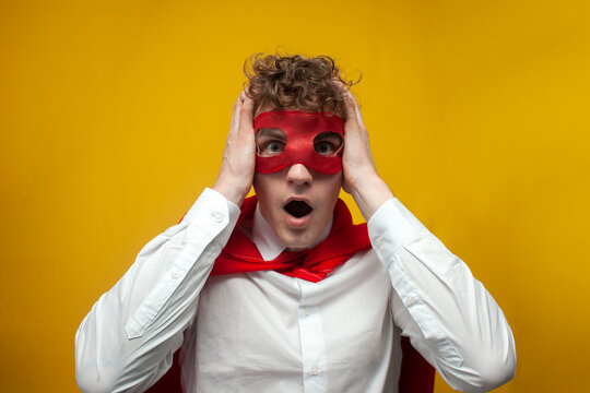 shocked guy in superhero costume shows surprise on yellow background, shocked superman