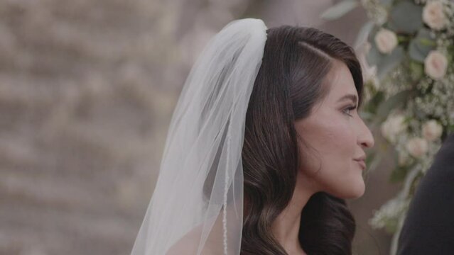 Beautiful, young bride nodding and laughing as she says "I do." Wedding ceremony. Shot in 4K 60FPS for high quality slow motion. Purchase entire event at wholesale price email willneatheryyahoo.com.