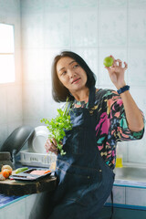 Portrait of asian thailand woman cooking in kitchen at home.