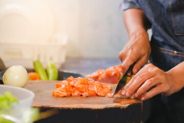 Closeup of Human hands cooking salmon menu in kitchen at home. 