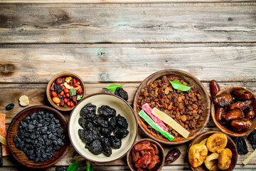 Assortment of different dried fruits in bowls.