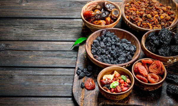Assortment of different kinds of dried fruits in bowls.
