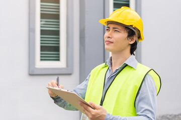 Building inspection, contractor asian young man, male inspecting home, reconstructed construction, renovation or check defect, before finish handing it over to client. Engineering worker, copy space.