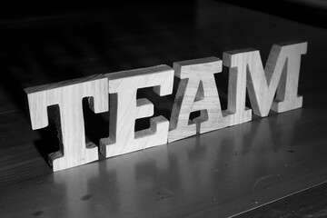 Team, text words typography written with wooden letter on black background, life and business motivation inspirational