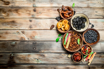 Assortment of different dried fruits in bowls.